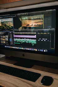 A sleek 4K monitor displaying vibrant video editing software interface with colorful timelines.