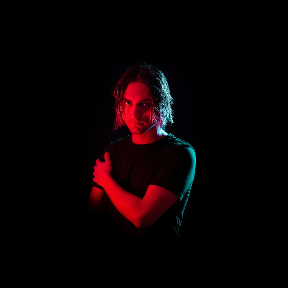 man in t-shirt with red light on face