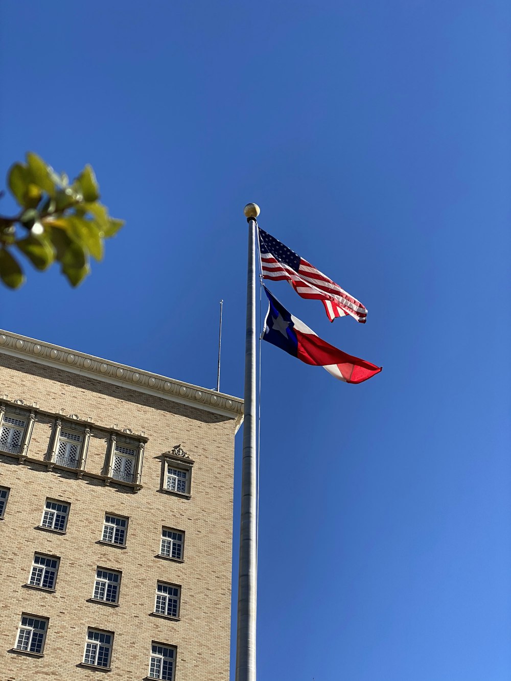 USA flag on top of pole near building during day