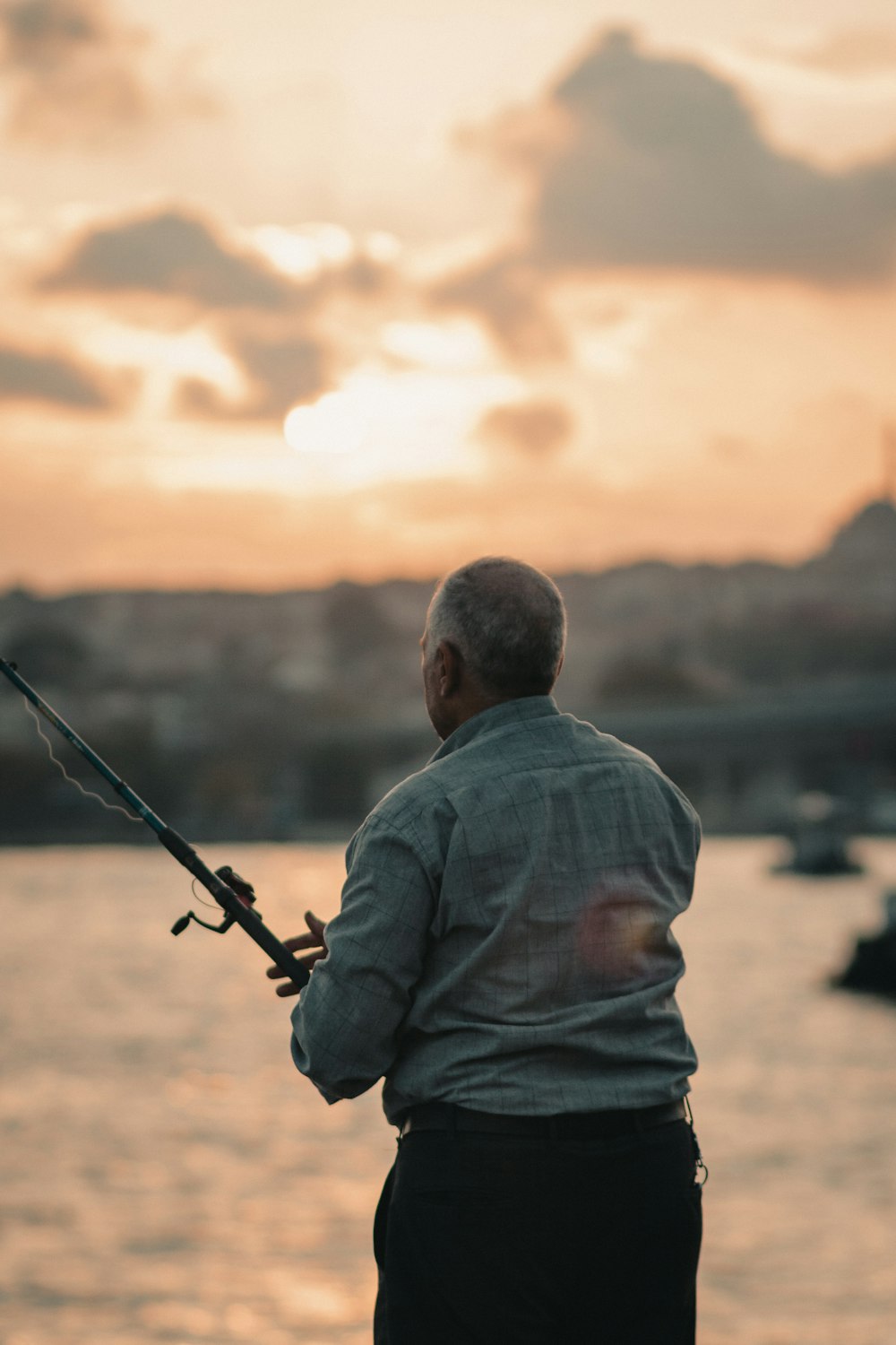 Un homme debout sur un quai tenant une canne à pêche