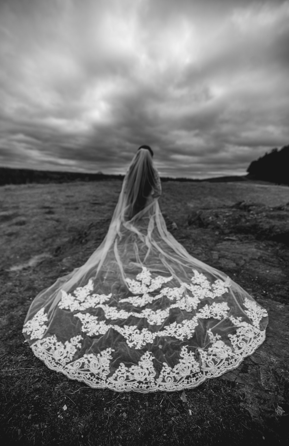 standing woman wearing floral gown at the field