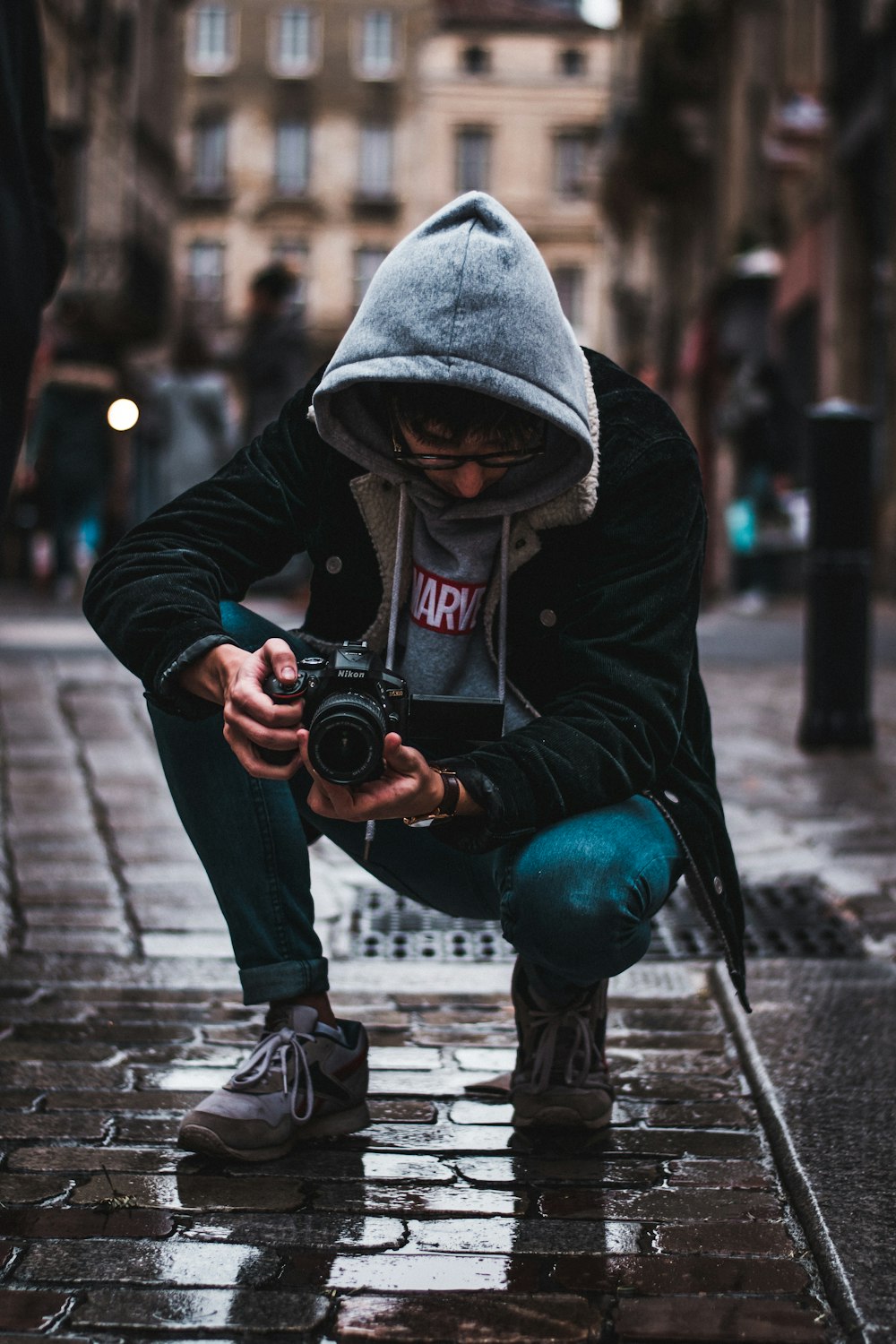 man holding black DSLR camera