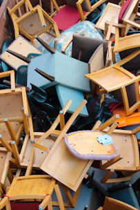 abandoned brown and blue wooden chairs