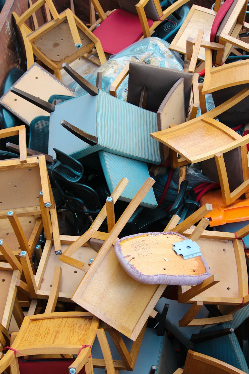 abandoned brown and blue wooden chairs