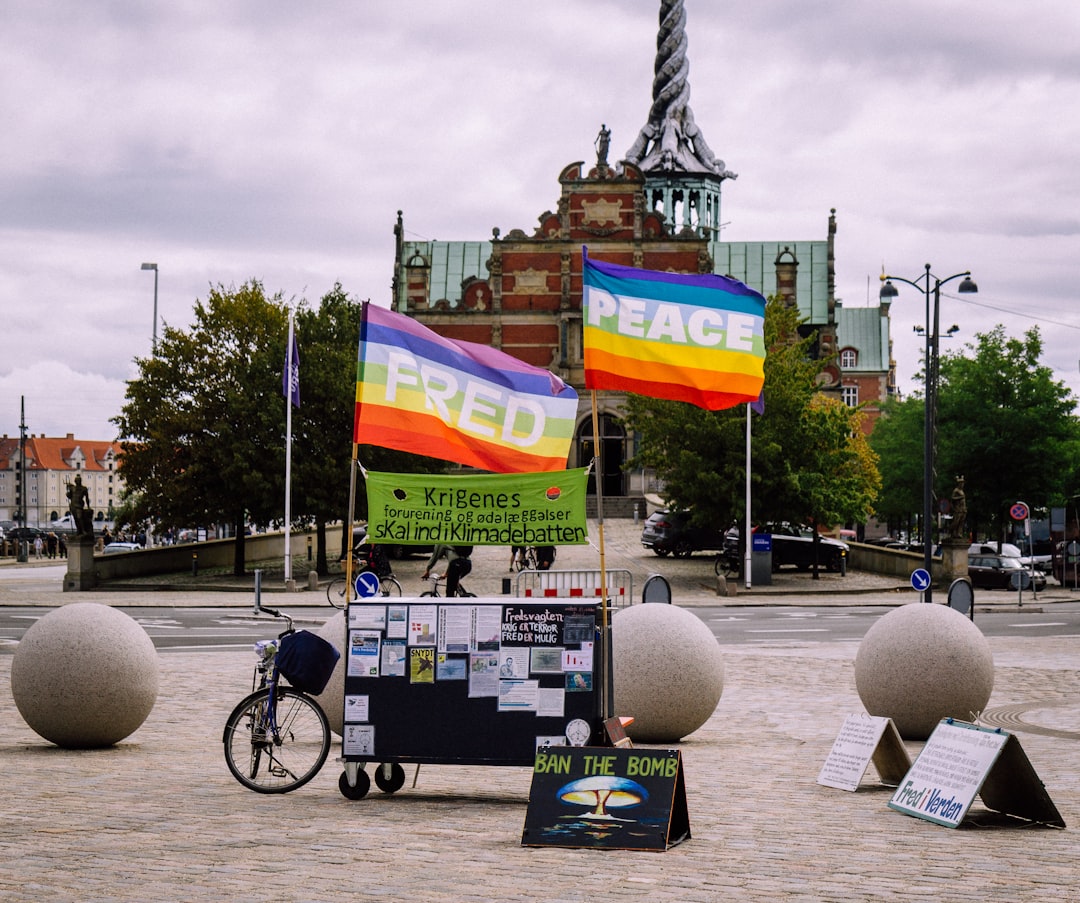 LGBT banner near bike on street viewing buildings during daytime