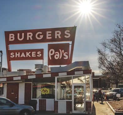 gray vehicle parking near Pal's burger and shakes store during daytime