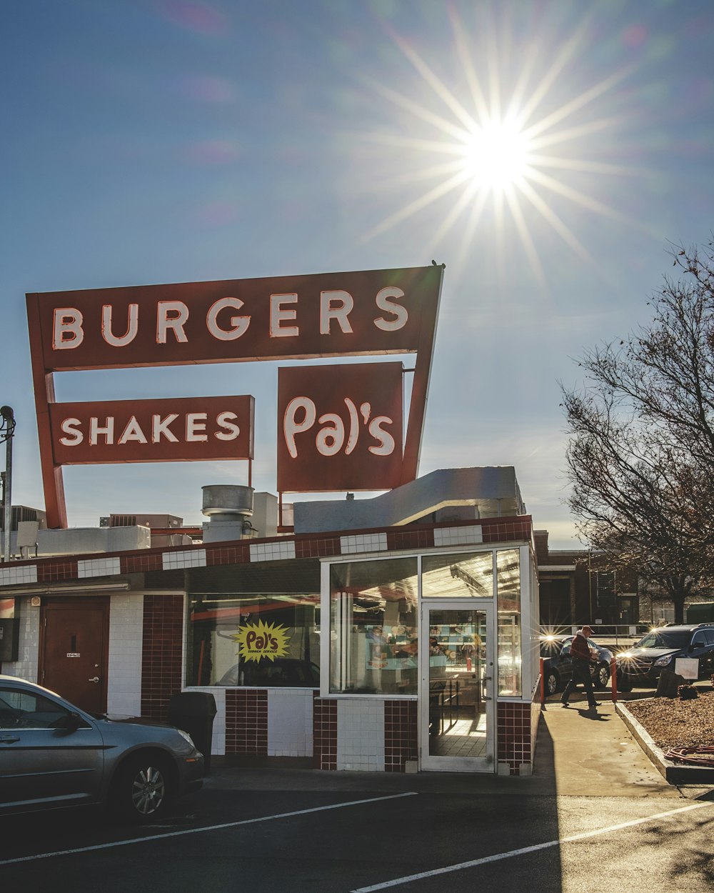 gray vehicle parking near Pal's burger and shakes store during daytime