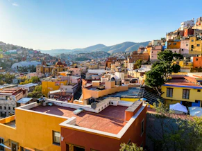 a view of a city with mountains in the background