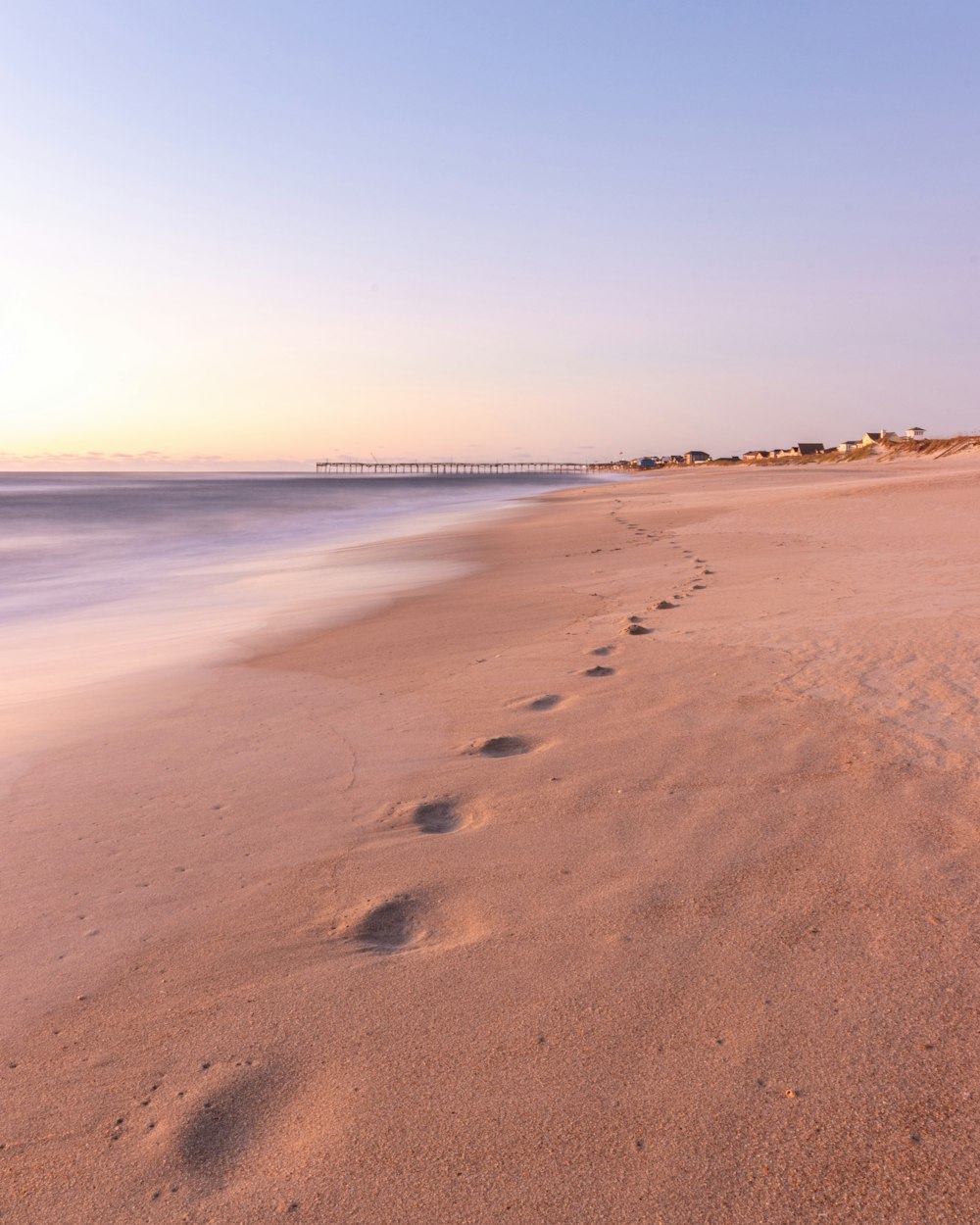 foot prints in the sands during daytime