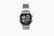 A silver digital wristwatch with a rectangular face displaying the time, world time map, and additional features. The watch has a metal strap and a robust, classic design.