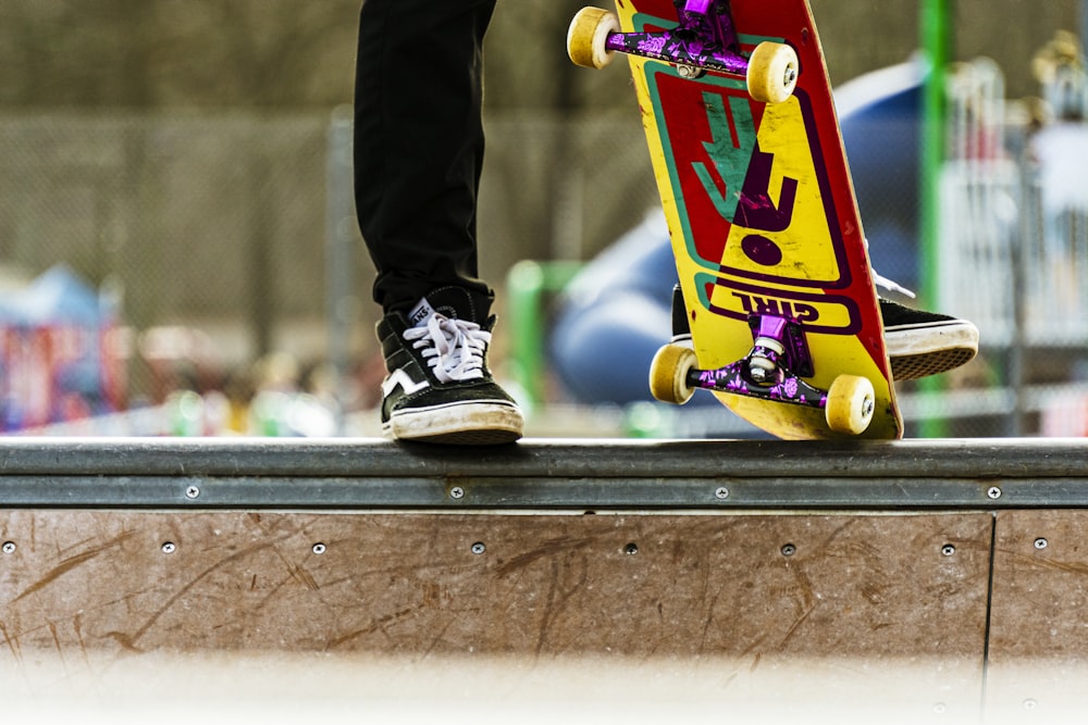 person stepping on a skateboard with multicolored print