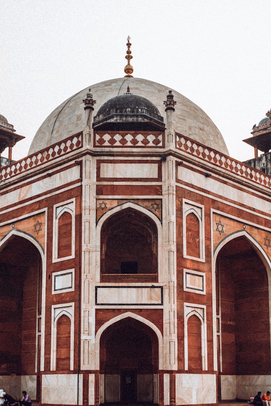 white and brown building during day in Humayun’s Tomb India