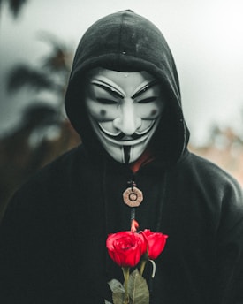 man wearing guy fawkes mask