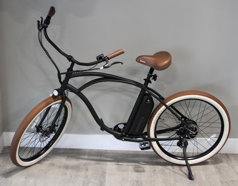 brown and black commuter bike beside wall