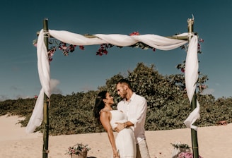 couple standing on shore during daytime