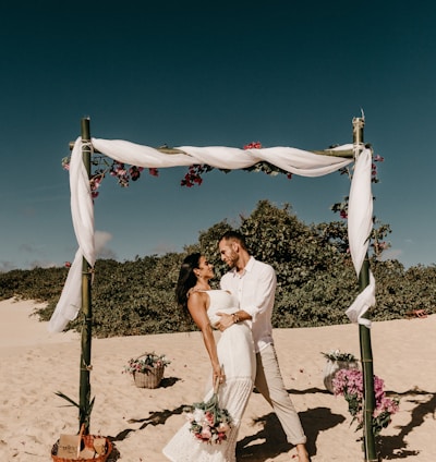 couple standing on shore during daytime