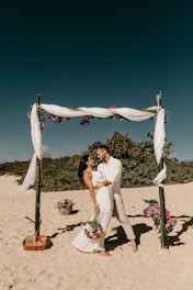 couple standing on shore during daytime