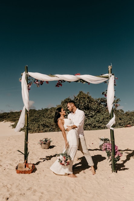 couple standing on shore during daytime
