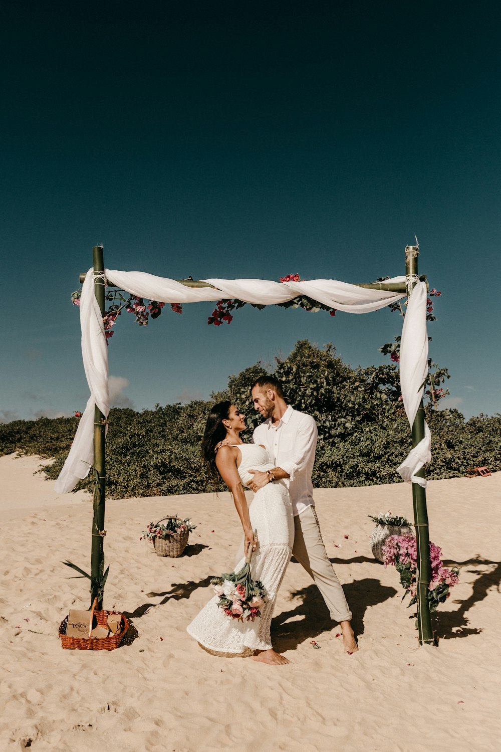 couple standing on shore during daytime