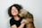dog kissing woman in black crew-neck shirt