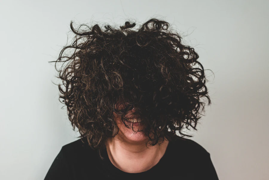 Before: dry, frizzy curls covering the face