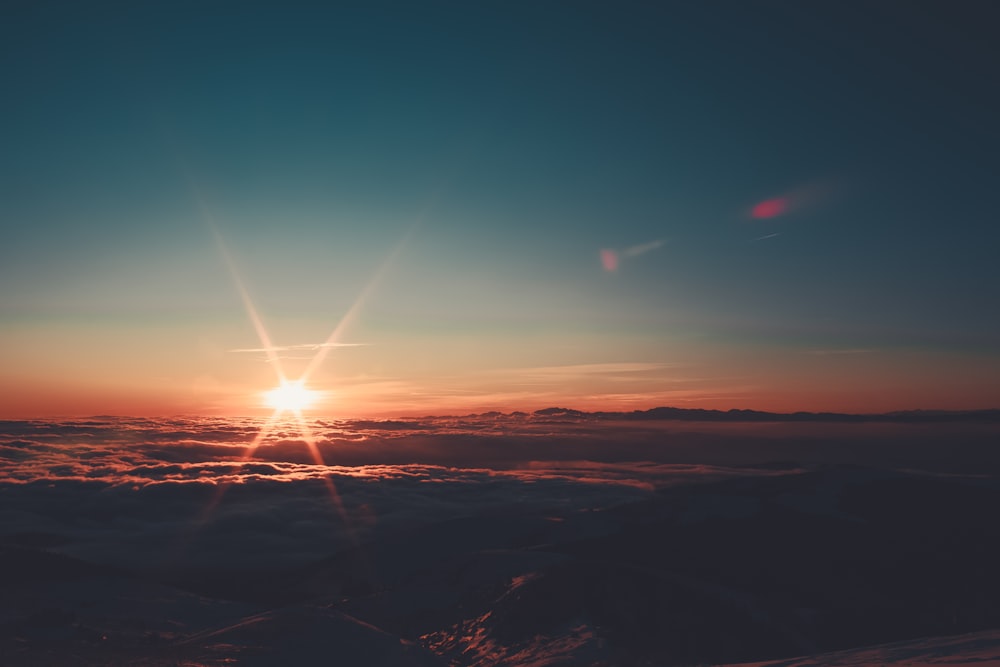 aerial photography of sea of clouds during golden hour