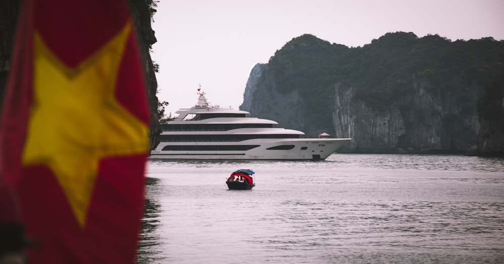 white yacht near islet during daytime