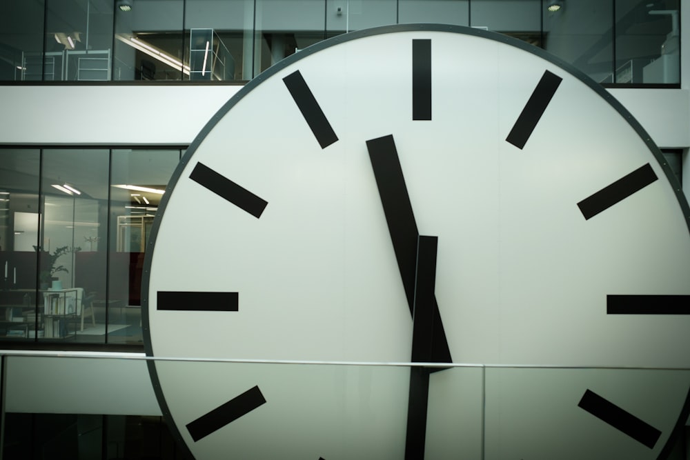 round white and black analog clock