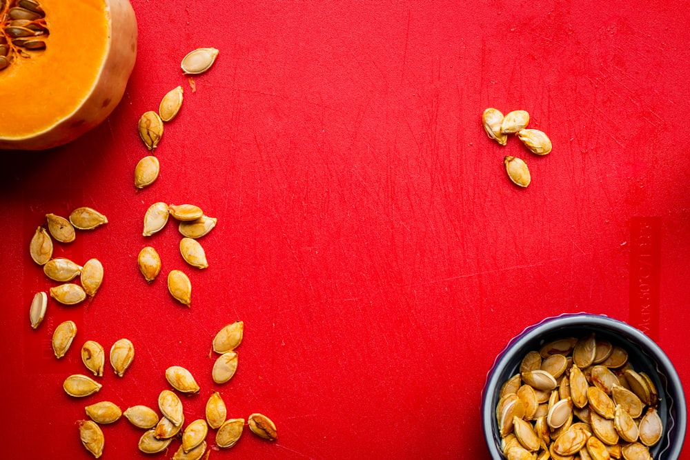 seeds on red surface and in blue bowl