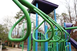 Close-up of a mechanical engineer inspecting a playground structure with measuring tools.