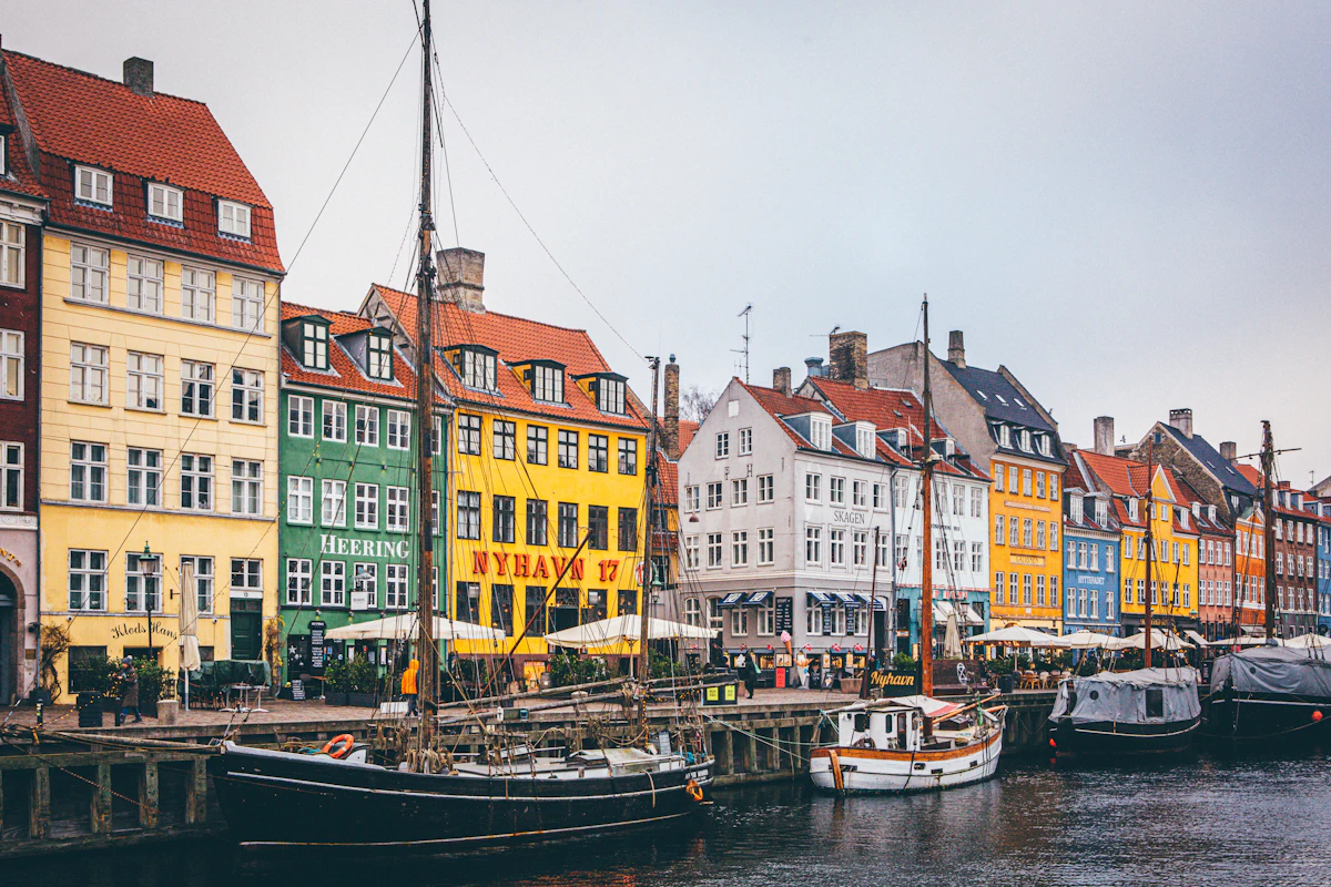 Colourful historic houses and wooden boats lining Copenhagen's Nyhavn harbour