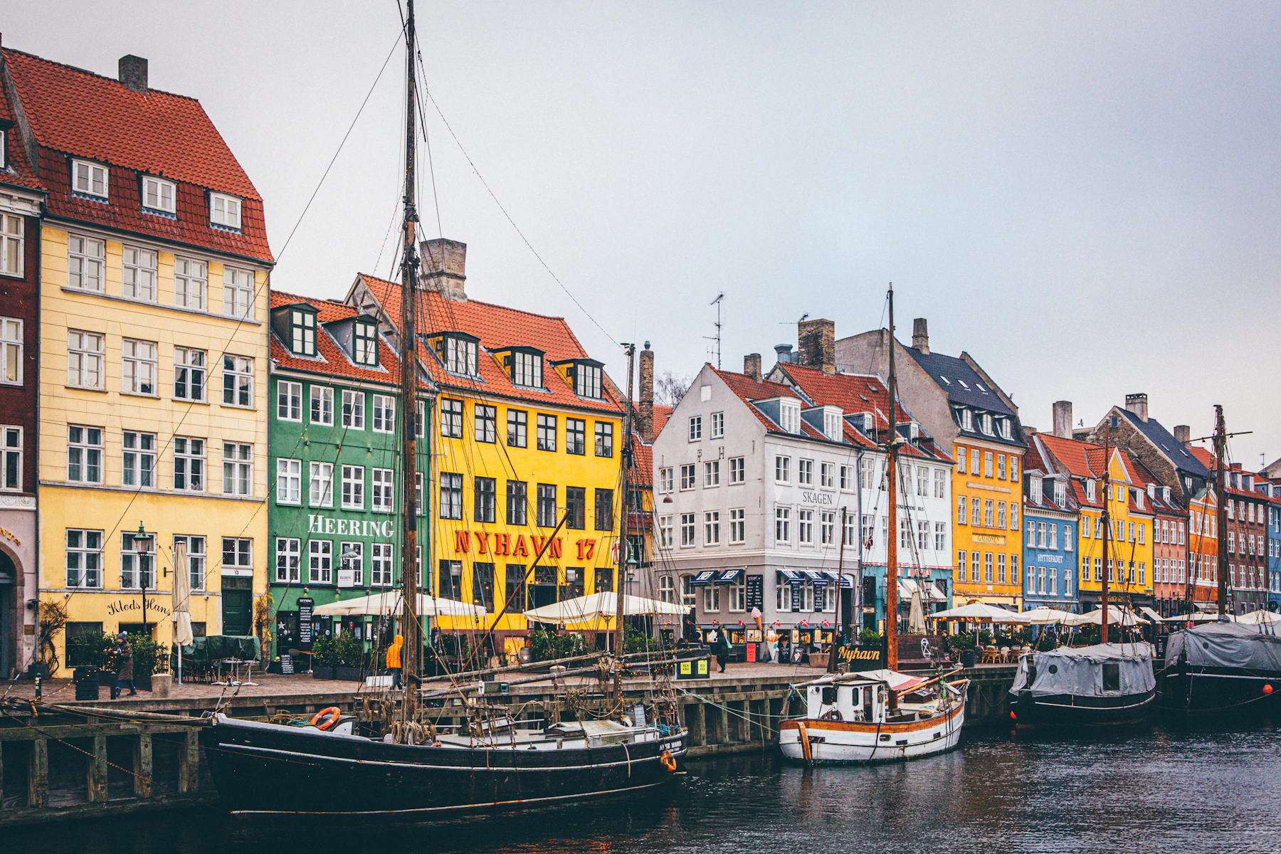 Colourful historic houses and wooden boats lining Copenhagen's Nyhavn harbour