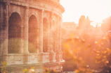 Historic stone ruins bathed in golden sunset light.