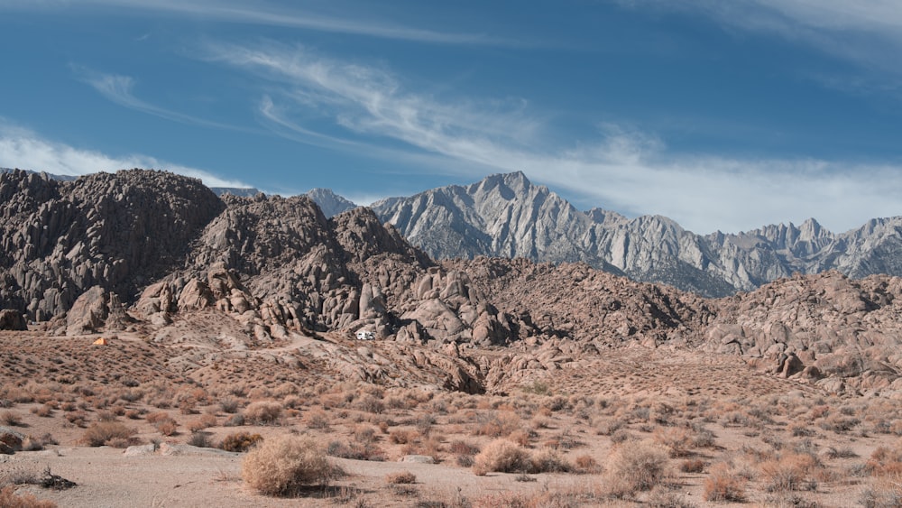 field near hills and mountains at daytime