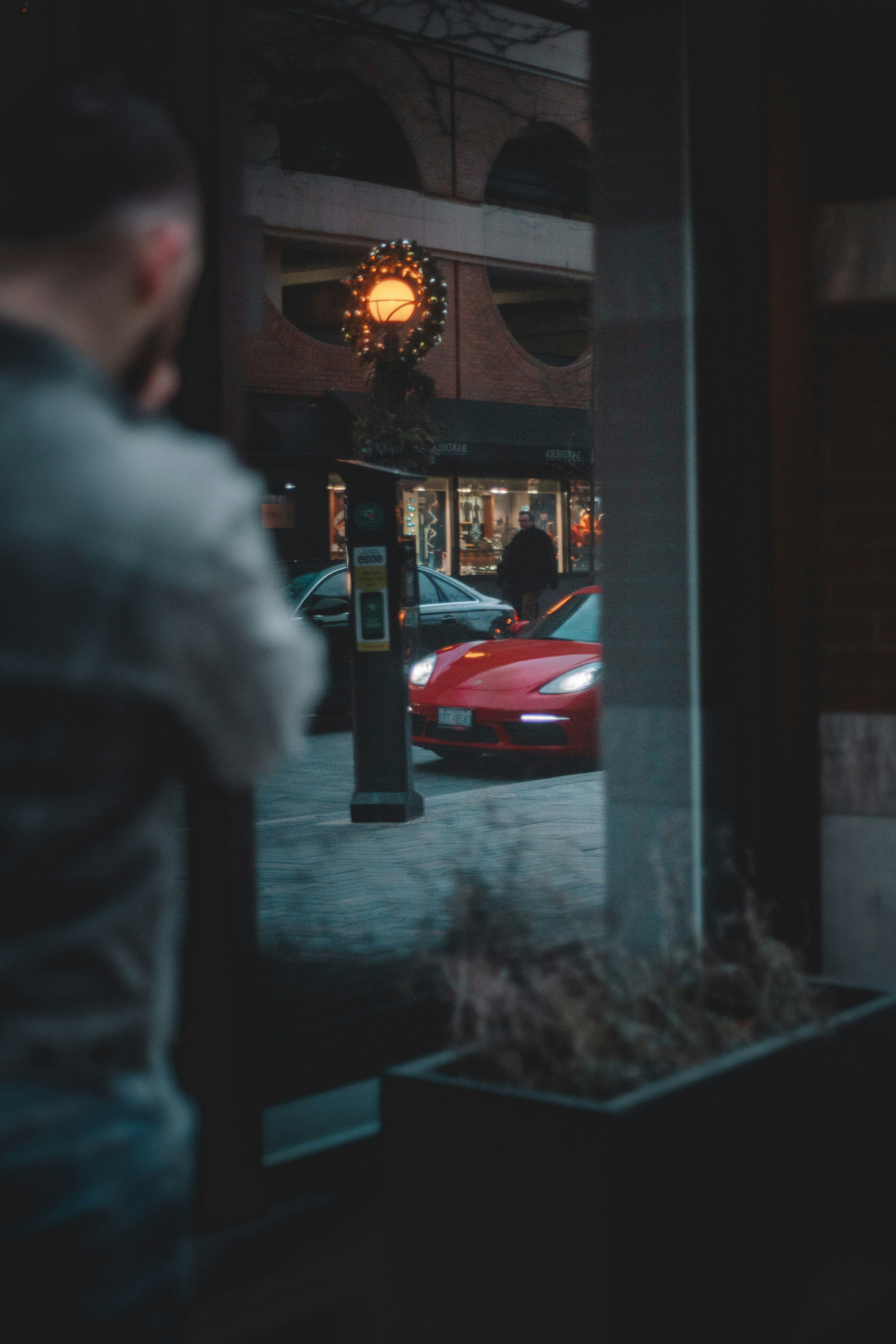 man walking beside wall during daytime