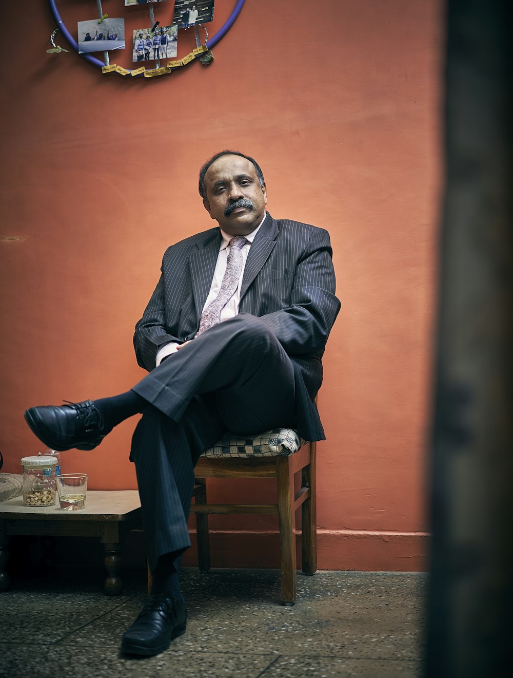 sitting man wearing black suit