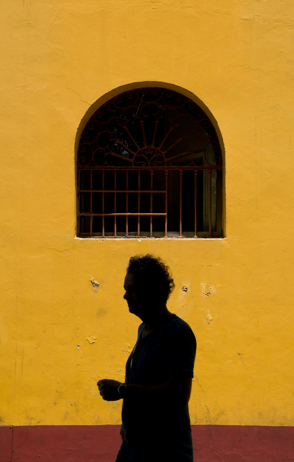man standing in front of wall