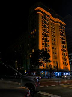 Exterior view of Tropicana 218 Macalister building illuminated at night