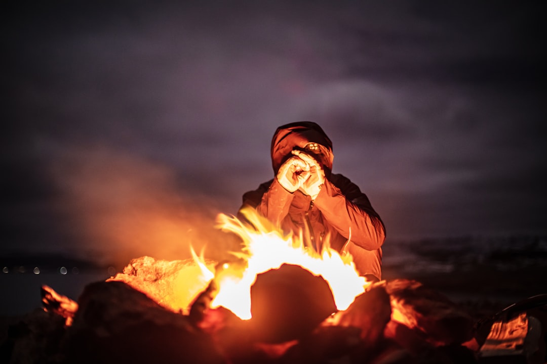 person sitting near the bonfire