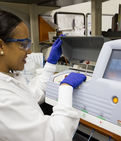 woman wearing white dress operating the machine