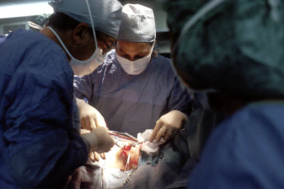 A surgeon carefully performing a digestive system operation in a modern operating room.