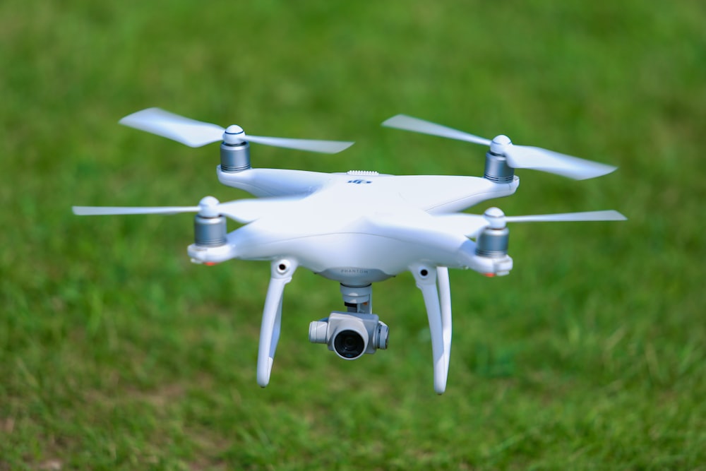 white DJI Mavic Pro drone above green field