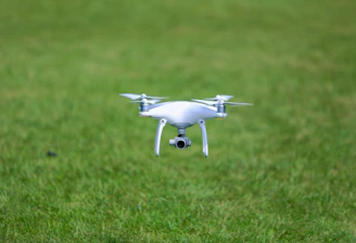 Drone flying low over a lush green crop field capturing multispectral images.
