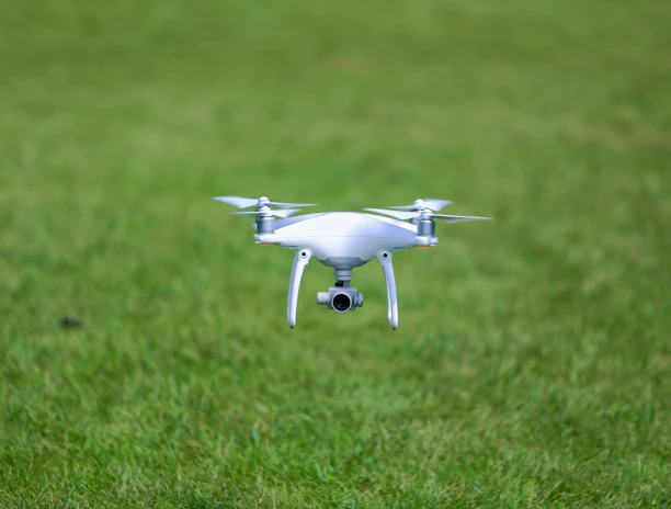 Drone flying low over a lush green crop field capturing multispectral images.