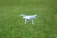 A drone flying over a lush green agricultural field, capturing data from above.