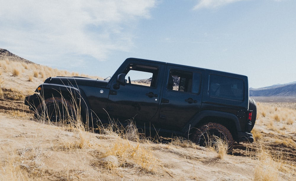 black vehicle on the desert photograph
