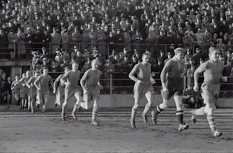 A vintage football team posing in green jerseys.