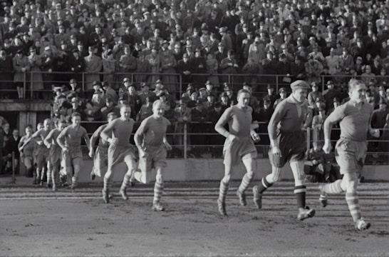 A vintage football team posing in green jerseys.