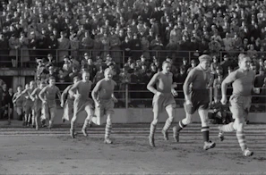 Vintage black and white footage of a classic football match with nostalgic atmosphere