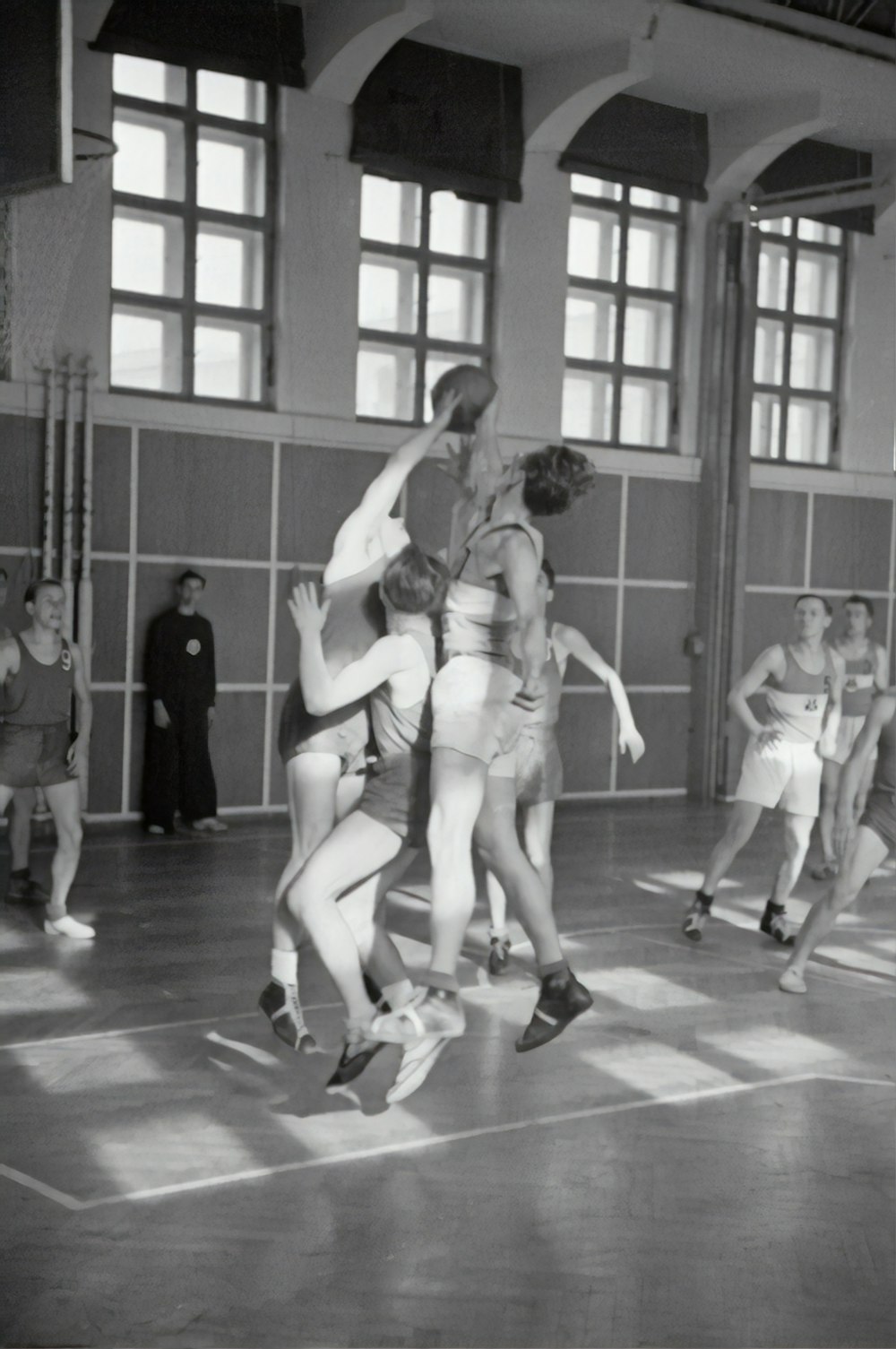 grayscale photography of men playing basketball